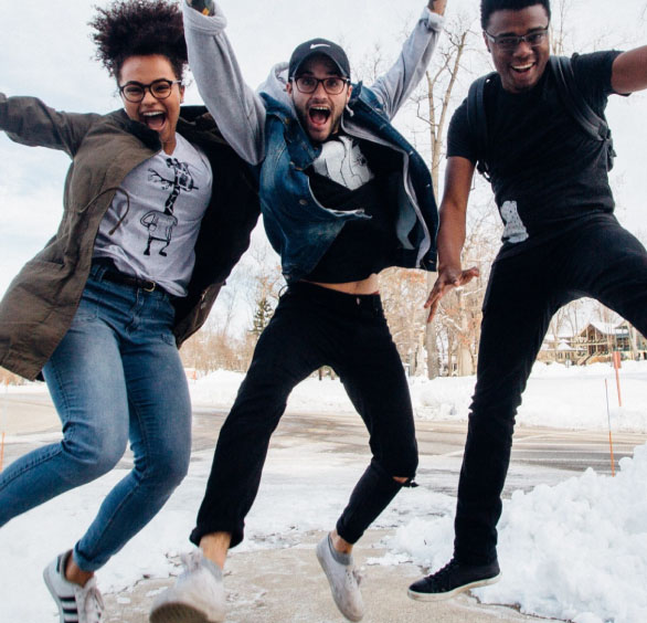 Three happy young people jumping for joy